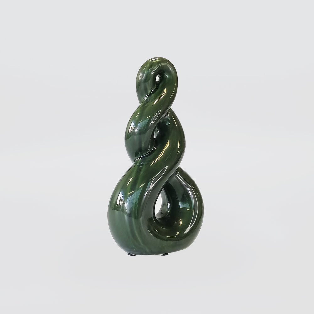 Green ceramic sculpture on a white background