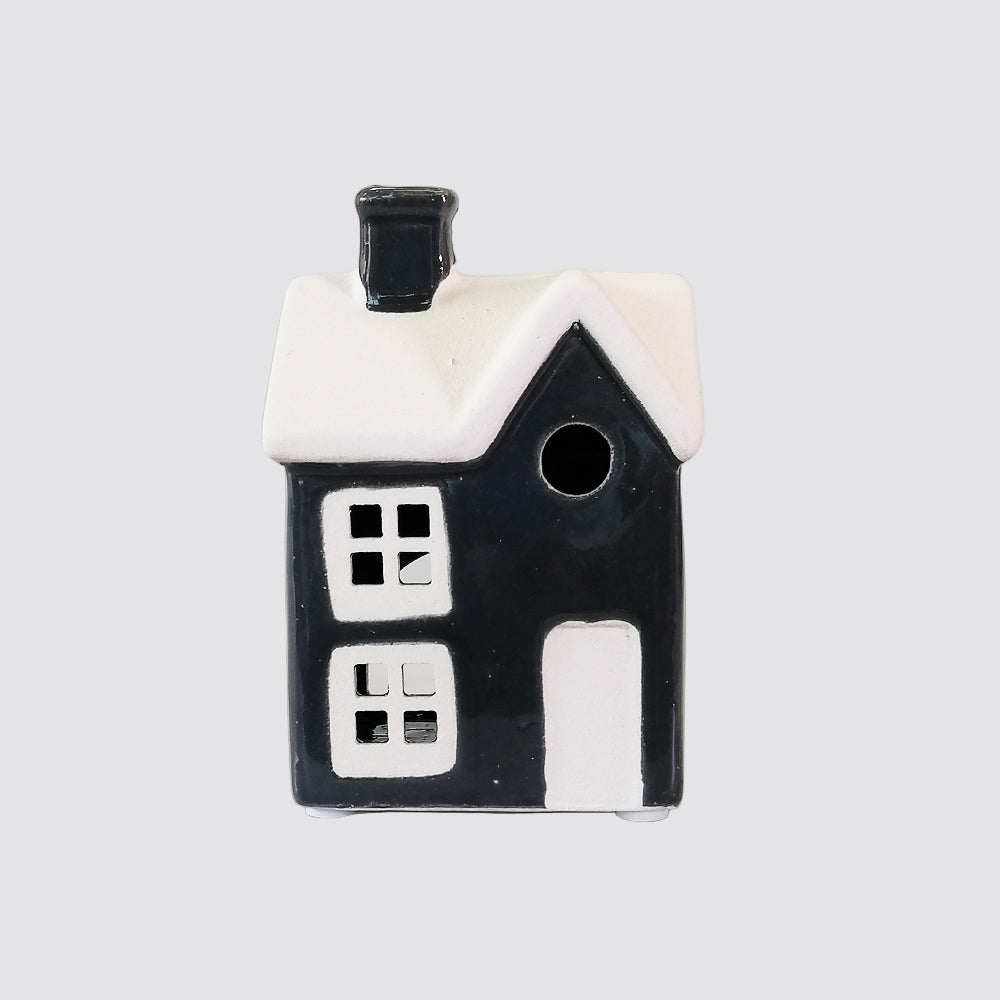 Ceramic house-shaped birdhouse with a white roof on a light gray background