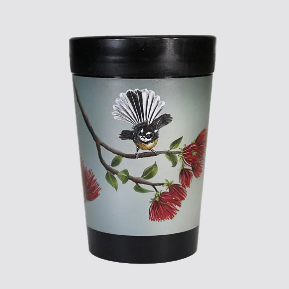Tumbler with a bird and flower design on a light gray background