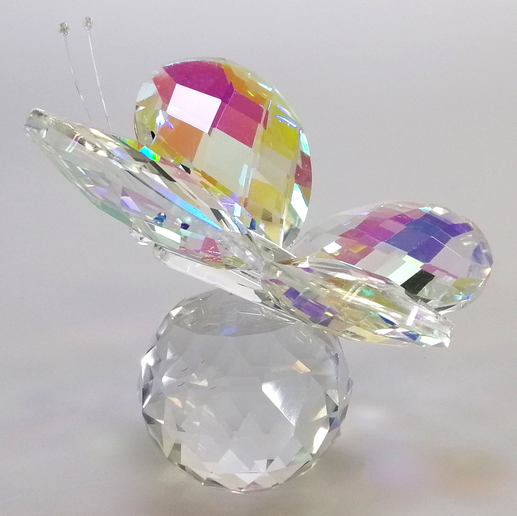 Glass Butterfly Resting On Glass Ball