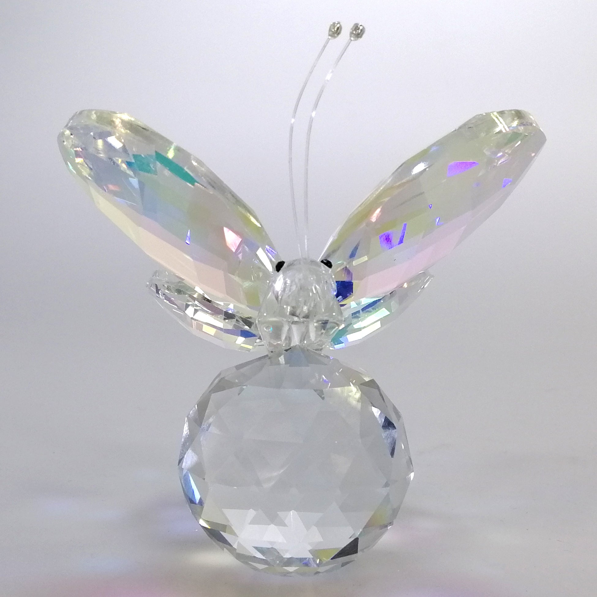 Glass Butterfly Resting On Glass Ball