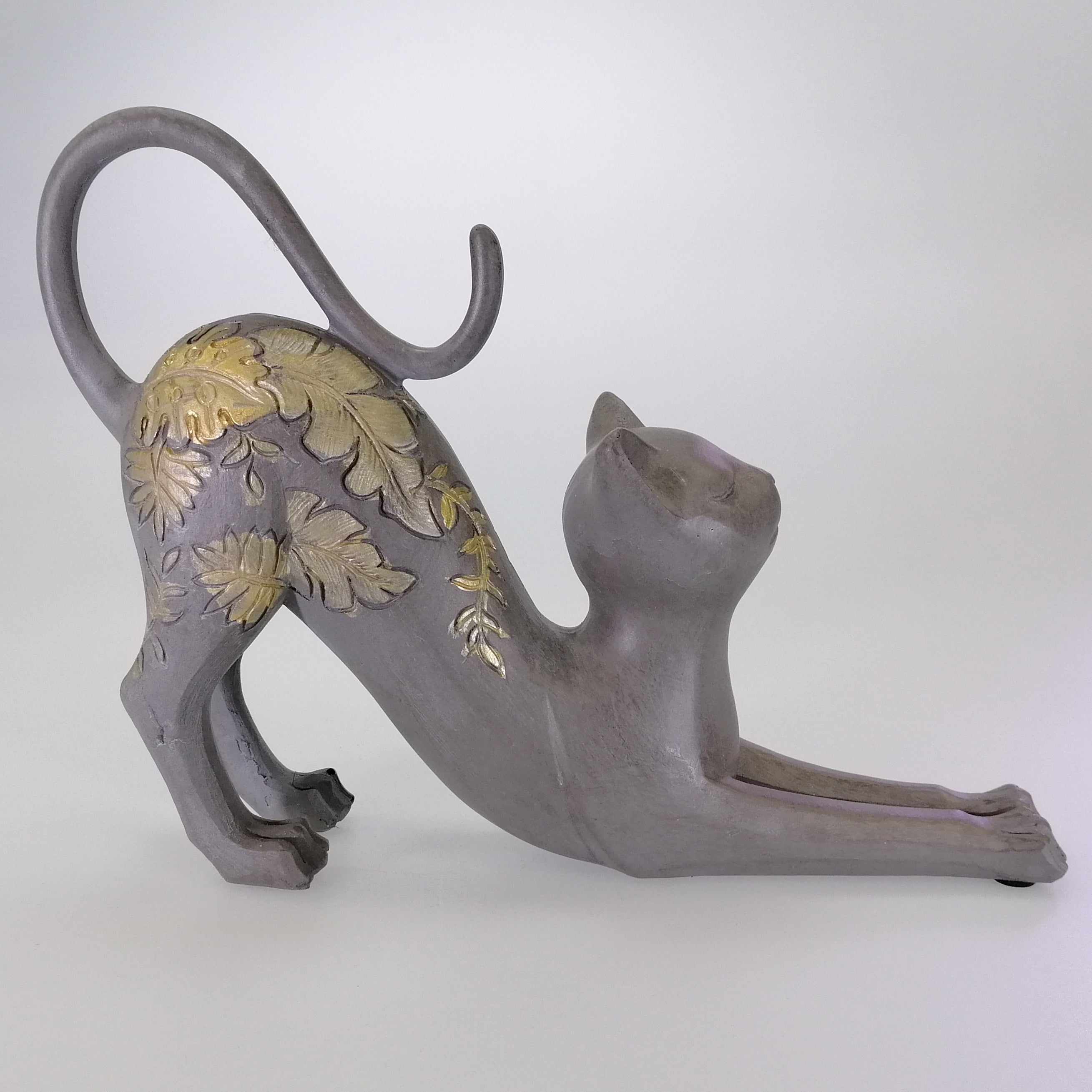 Stretching Cat Figure with Gold Accents